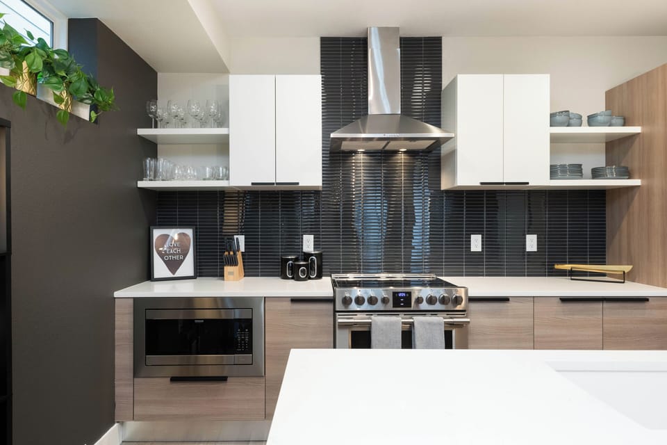 Large Kitchen with electric 6-burner stove, dishwasher, island, and coffee bar