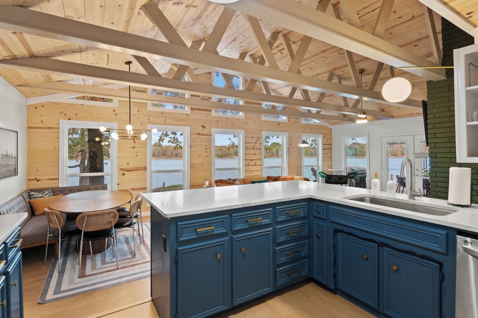 Updated kitchen boasts quartz countertops and a deep stainless steel sink.