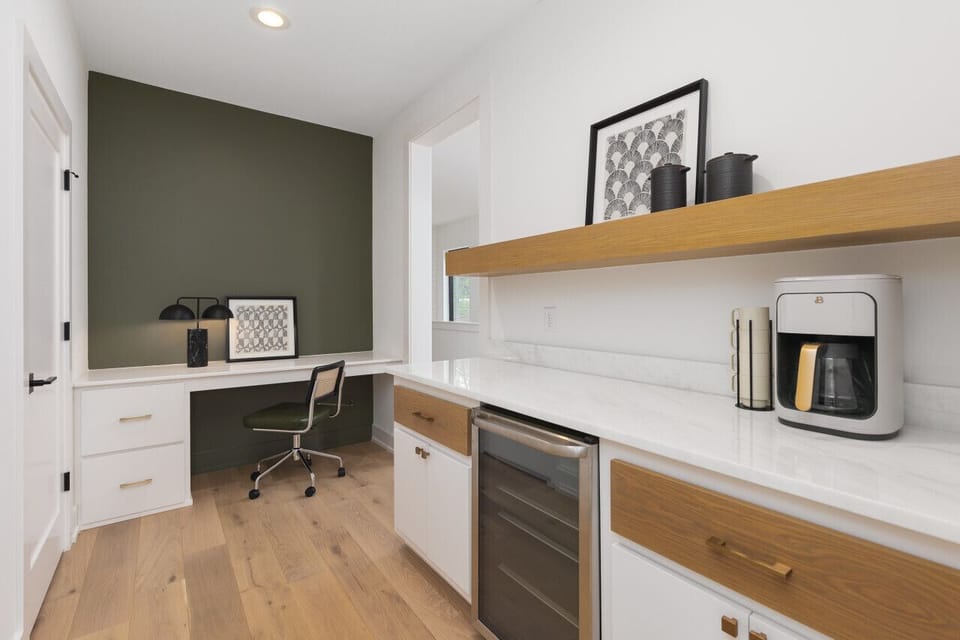 Desk + chair to work from, along with an upstairs coffee bar area + mini fridge.