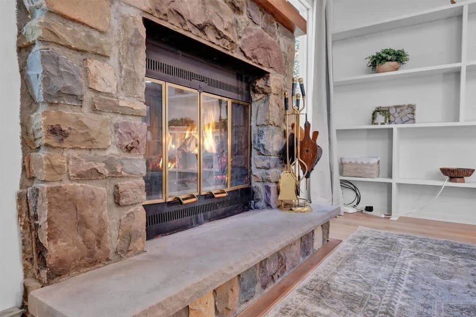 Warm Living Room Fireplace with Built-In Shelving
