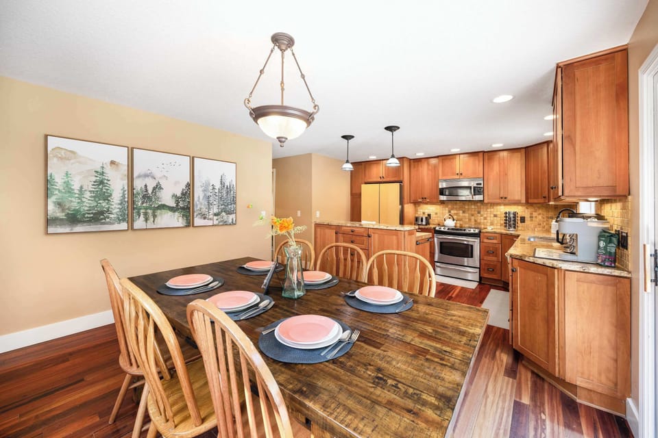 Charming dining space featuring natural light and artful decor, complemented by a fully equipped kitchen that makes dining in a pleasure.