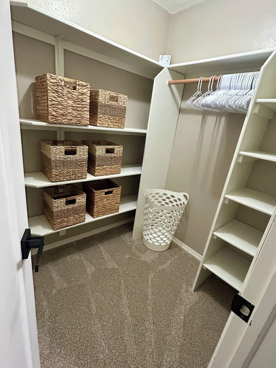 King Basement Bedroom walk-in closet, storage bins, shelving, and hangers.