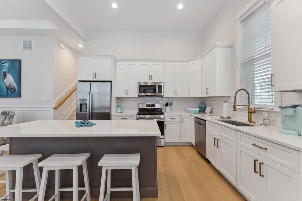 Sleek Gourmet Kitchen with 4-Barstool Island & Stainless Appliances