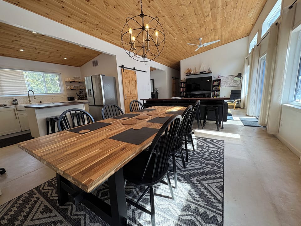 Casual stool seating for 5 at side and 2 at kitchen island and 6 at dining table