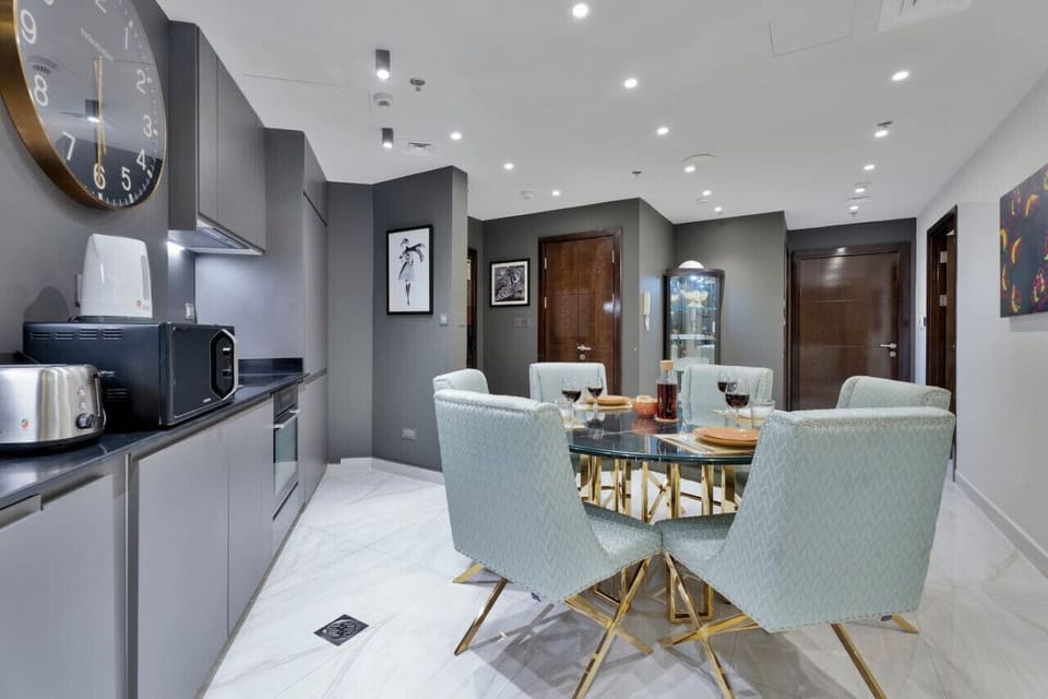 Dining Room: Enjoy elegant meals at this chic glass-topped table with stylish teal chairs!