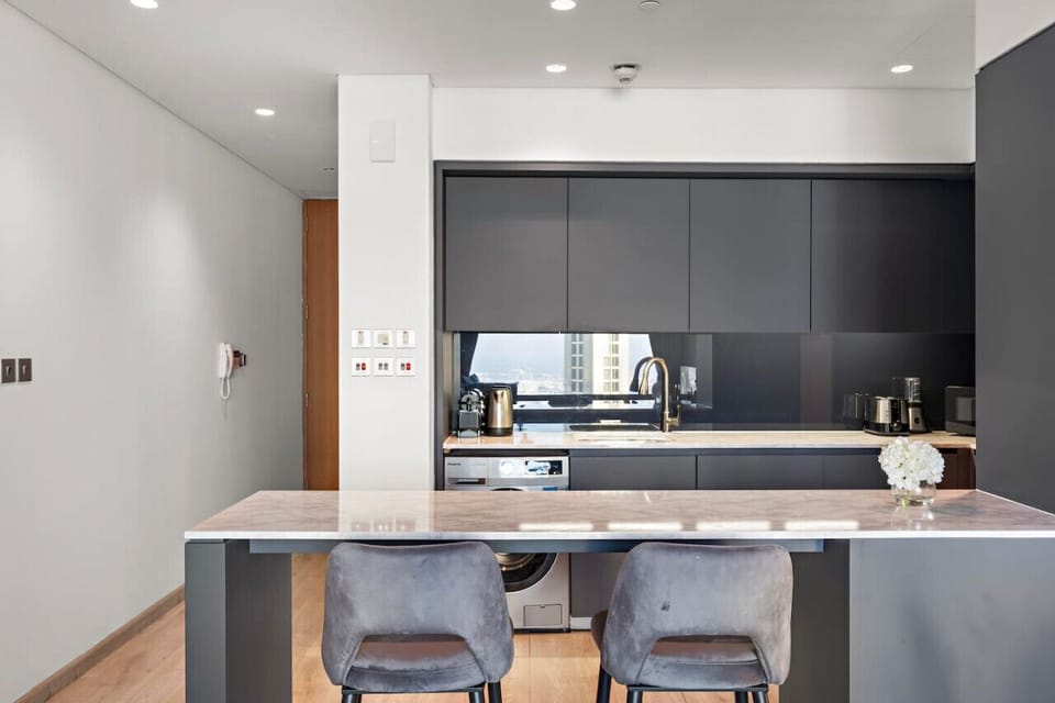 Modern Kitchen: Sleek finishes and stunning views make cooking a joy in this stylish space!