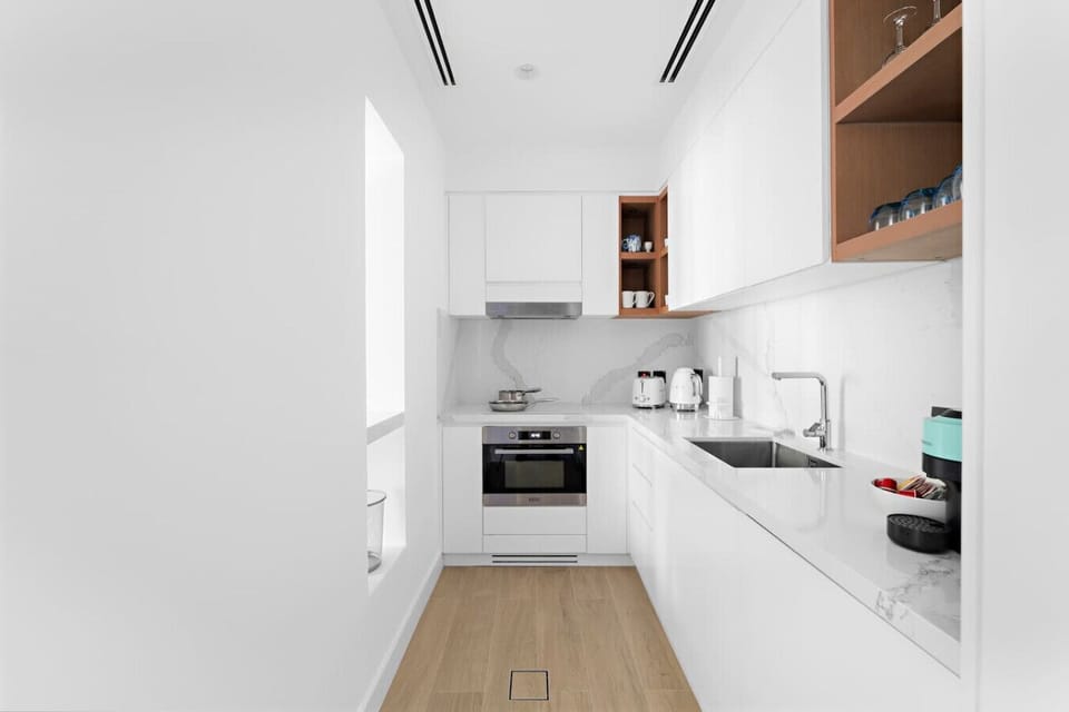 Kitchen: Sleek design and modern appliances make meal prep a delight in this airy kitchen!