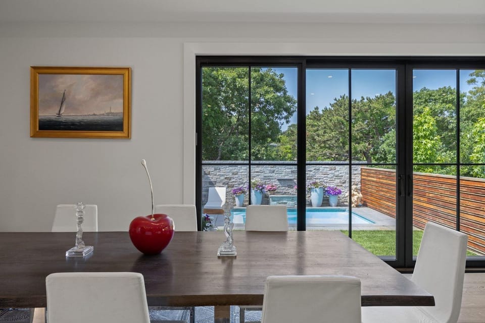 Dining area with sliders to private yard with pool