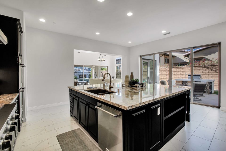 Gourmet kitchen island with sink and direct patio access