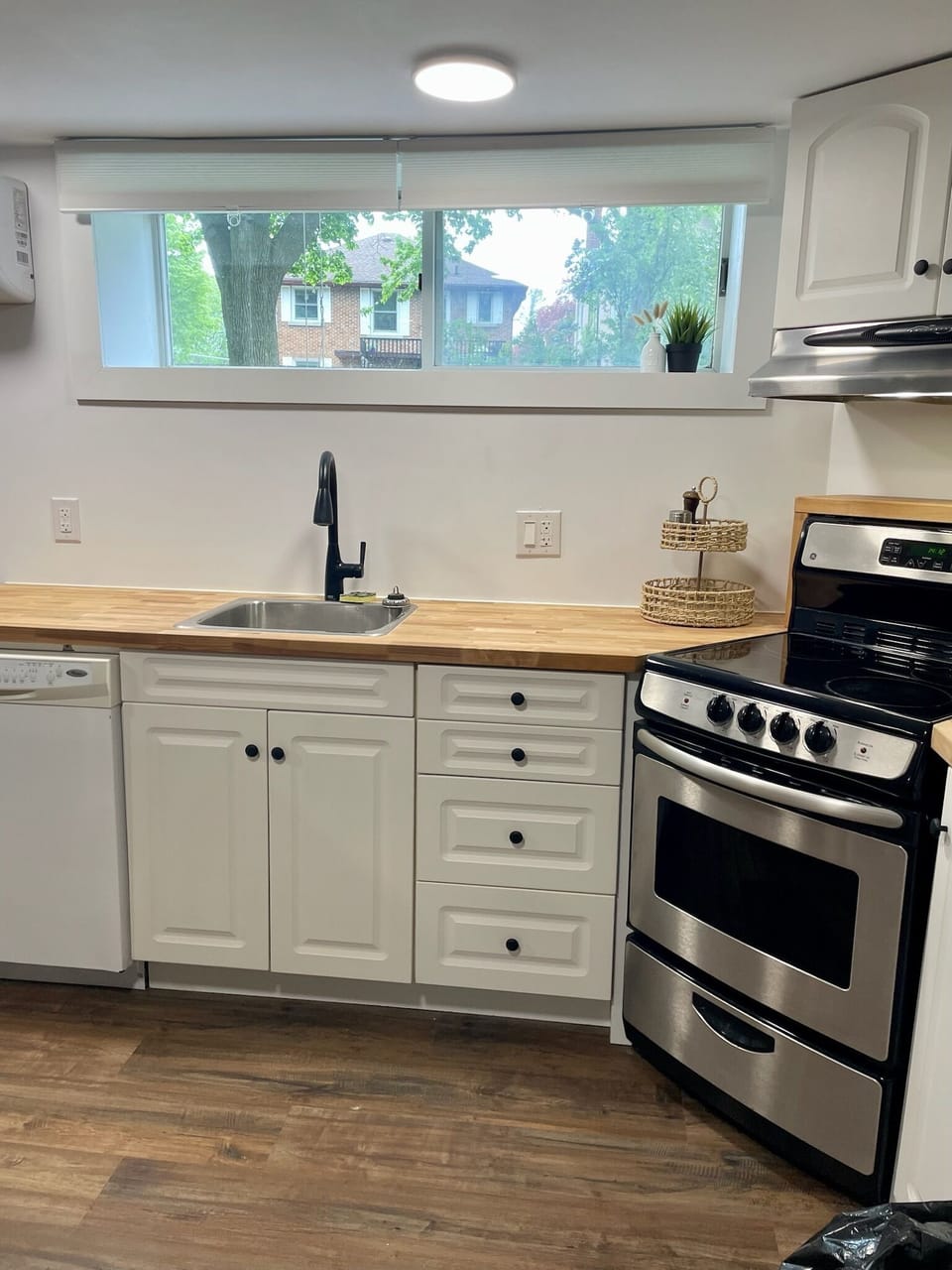 Modern kitchen with stove, microwave, dishwasher, coffee maker, and all the things you need