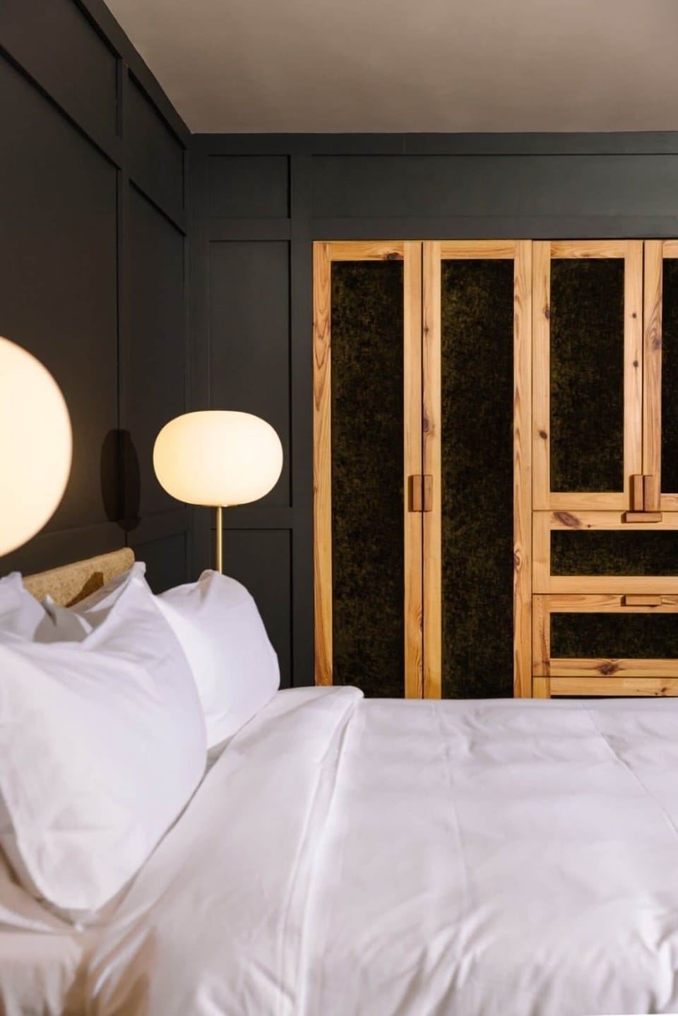 Sink into crisp linens beside warm, softly glowing lamps.