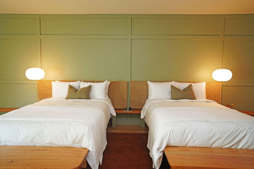 Stretch out on twin beds in a calm, modern room.