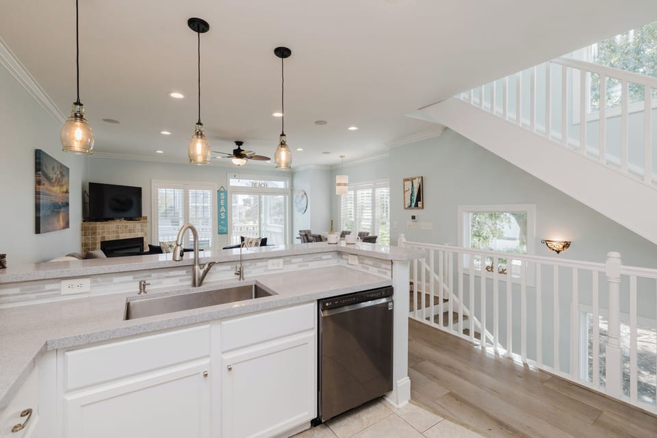 Modern kitchen fully stocked with cookware, an air fryer, Keurig and standard coffee maker, and everything needed for cooking meals and entertaining.