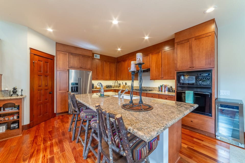 Gorgeous chef's kitchen with large, solid granite, island.