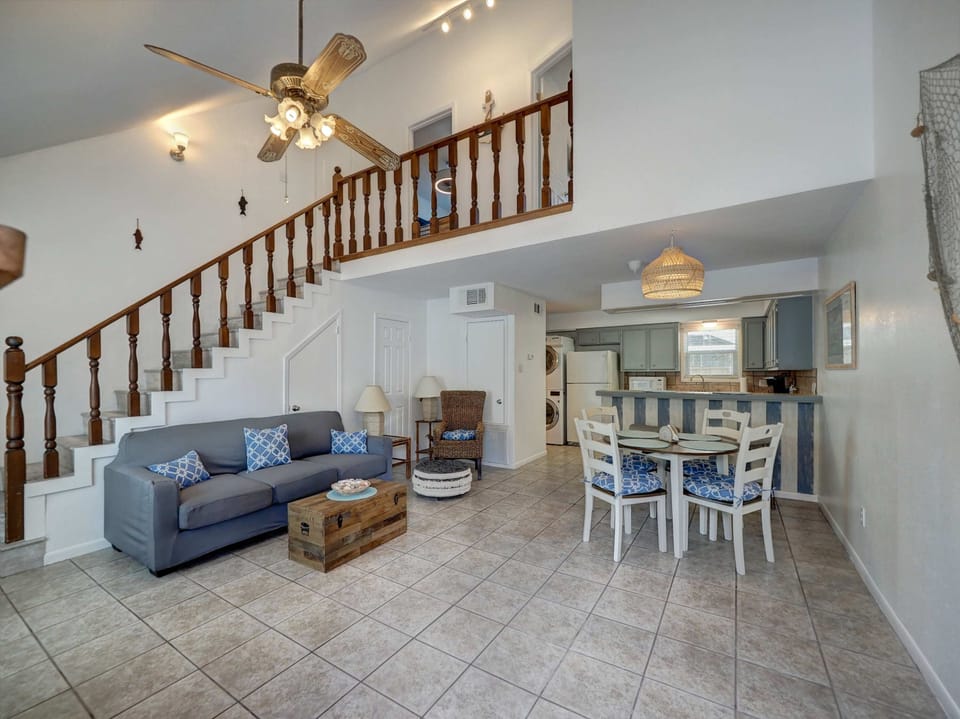 Our living room boasts soaring ceilings and an open floor plan, creating a bright, welcoming space perfect for gatherings.