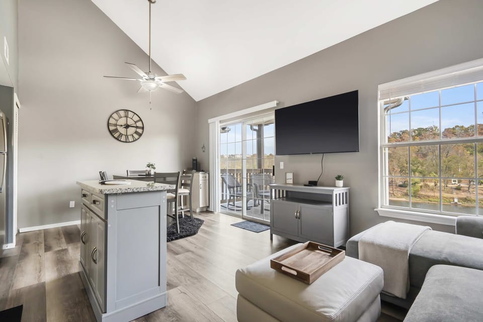 Bright living area with queen sofa sleeper, Smart TV, and lake view 