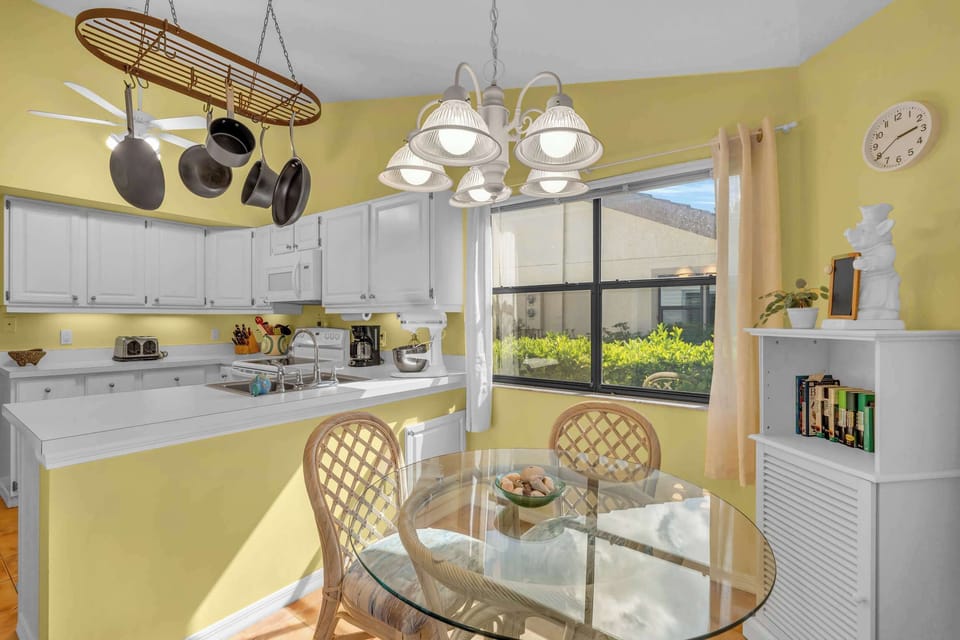 The breakfast nook is casual and is bright and sunny and seats 4 
