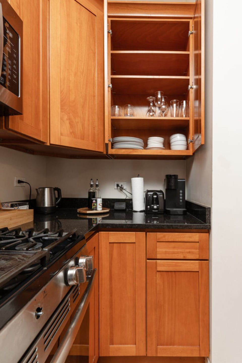 Channel your inner chef in this fully equipped kitchen, featuring stainless steel appliances, bar seating, and a dining table