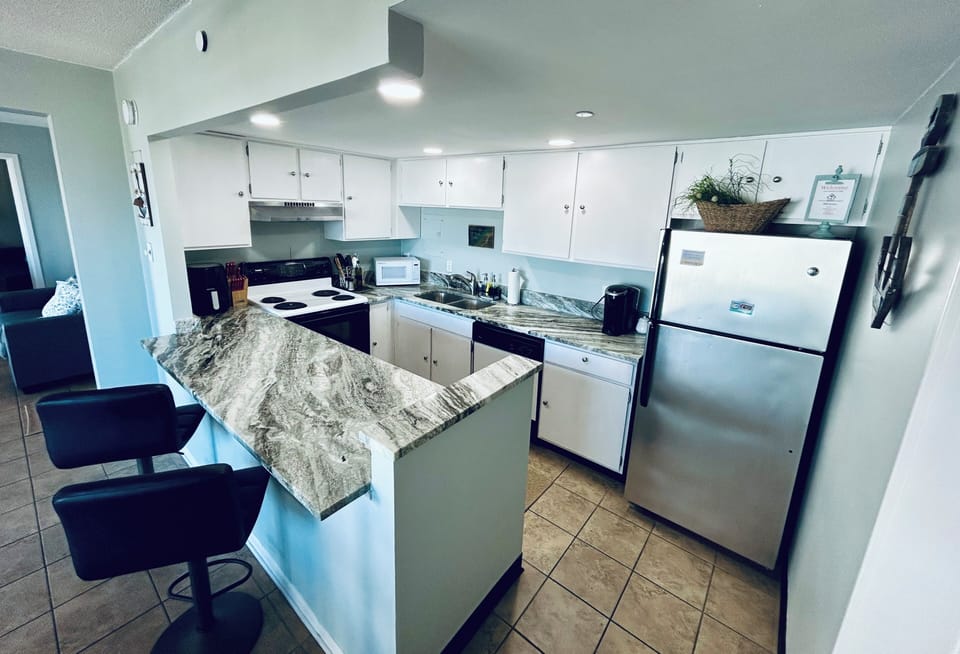 Open kitchen with 2 barstools, fully stocked with everything you need to cook