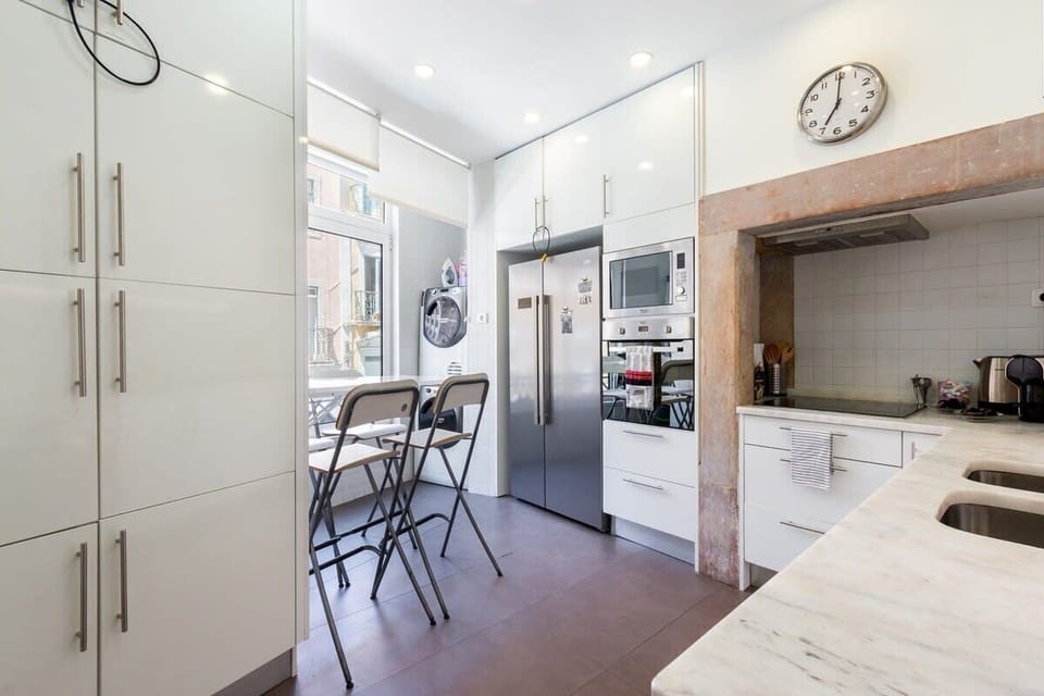 The kitchen is fully equipped with a washer and dryer for clothes.