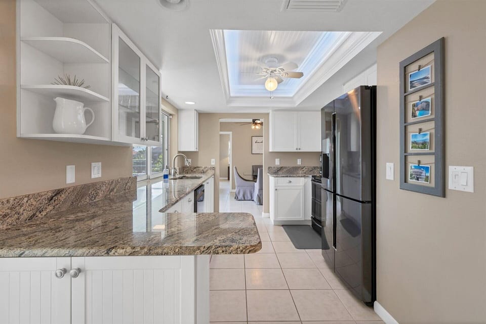 Fully-equipped kitchen with gorgeous view of pool and canal beyond