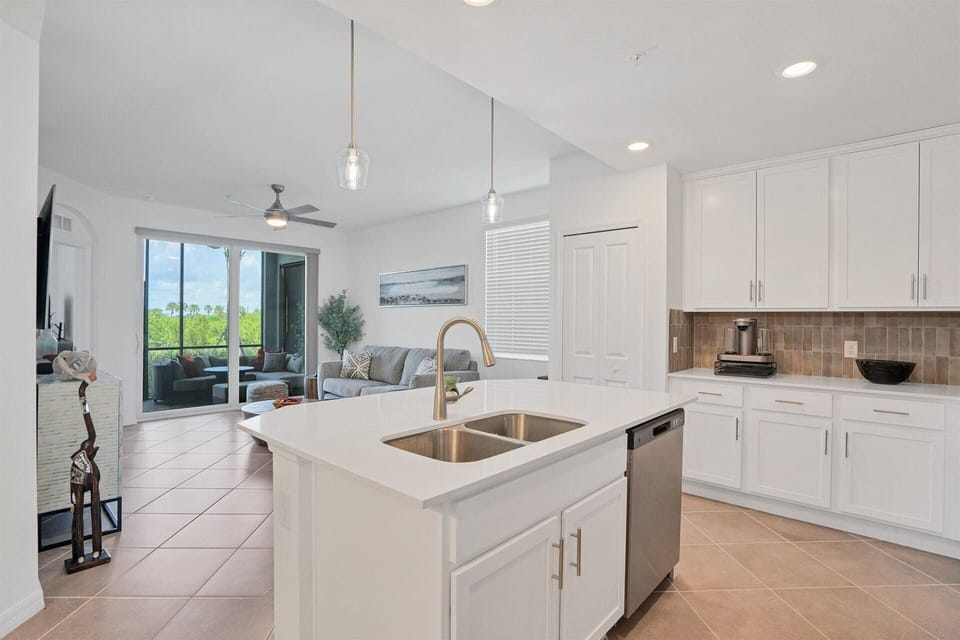 Bright, fully-equipped kitchen overlooking dining room &amp; living room. Kitchen island seats 2