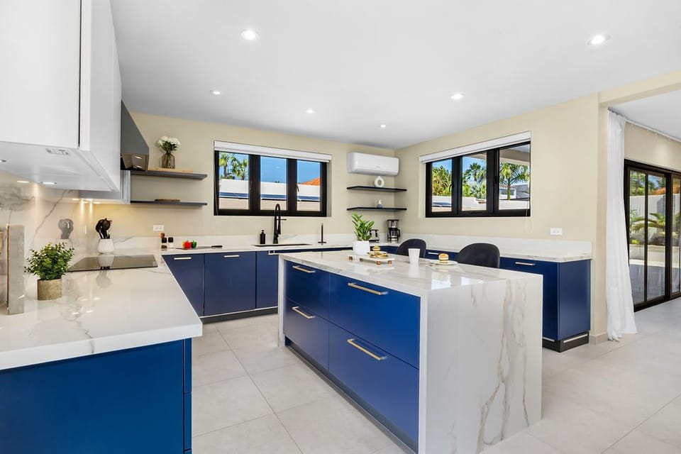 Cook up a feast in the fully equipped kitchen featuring high-end appliances, a central island, and all the essentials for creating delicious meals for your group