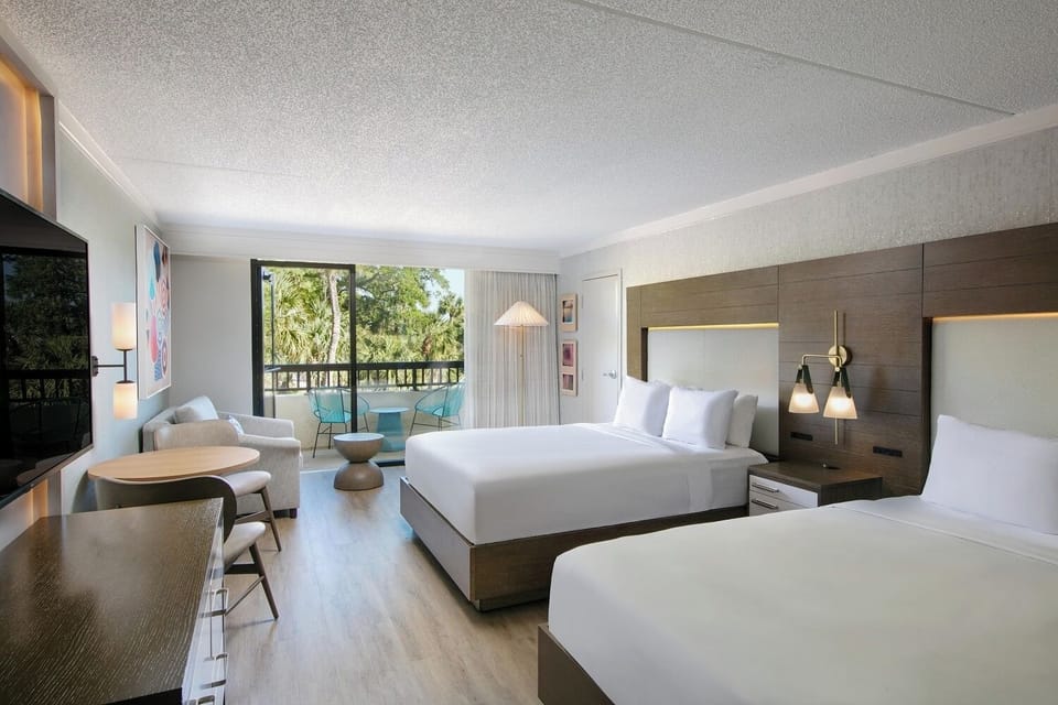 Unwind in a bright room with beds and balcony views.