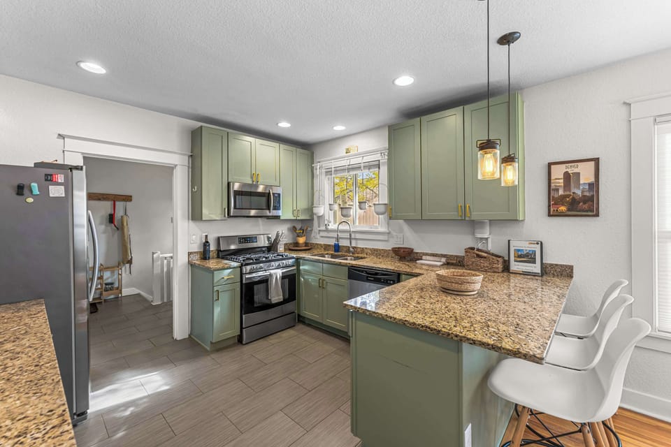 There is also a countertop with 3 chairs.