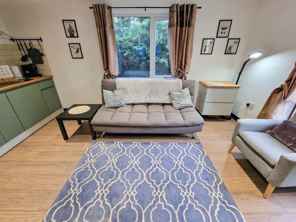 Relax in the spacious living room with a comfy sofa bed, perfect for extra guests.