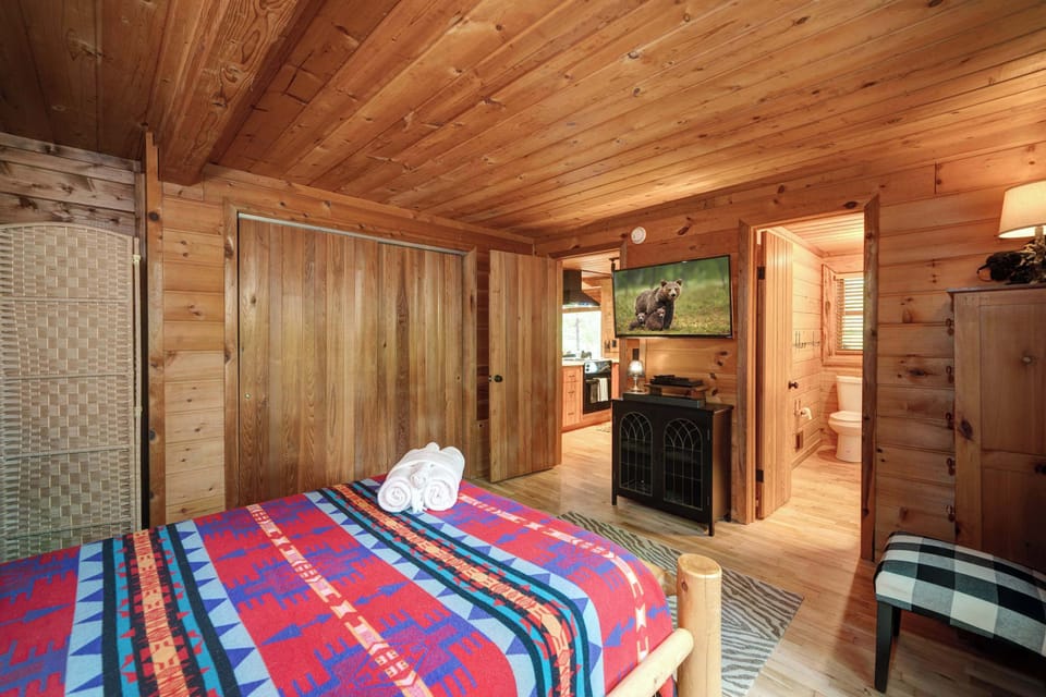 This main-level suite boasts a private ensuite bath, plush full bed, & laundry