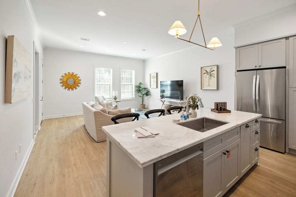 Sleek & Spacious! Enjoy the open-concept design of this modern living room, where style meets comfort in a bright, airy space.