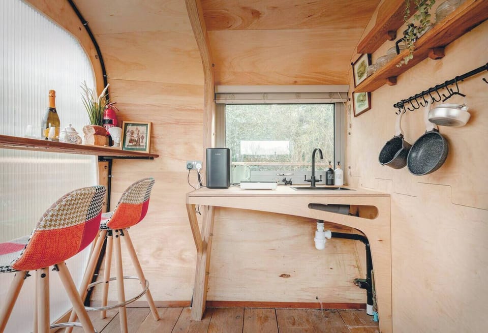 Functional Kitchen Nook Compact kitchen with essential amenities, stylishly integrated into the wooden cabin. Included breakfast space. The kitchen includes; Air-Fryer, induction hob, fridge, microwave, toaster plenty of utensils and a French press.