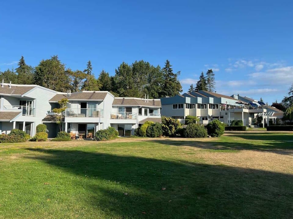 Ground floor unit (second from left) with patio table and chairs.  