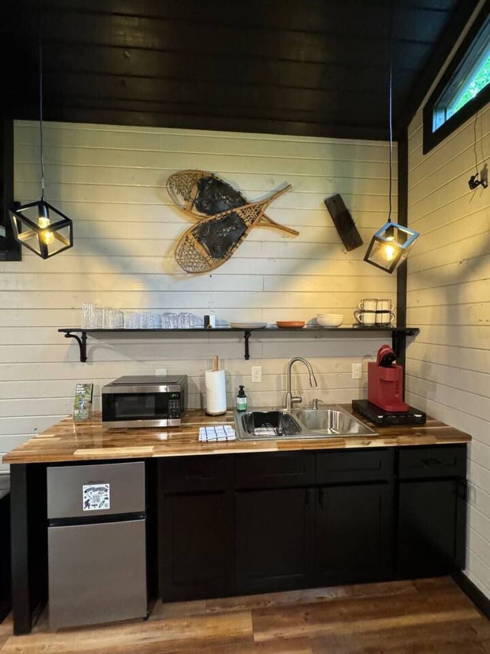 Cute kitchenette provides mini fridge, microwave, toaster, and Kuerig coffee maker. All of the dishes are provided including bowls, plates, cups, mugs and silverware.