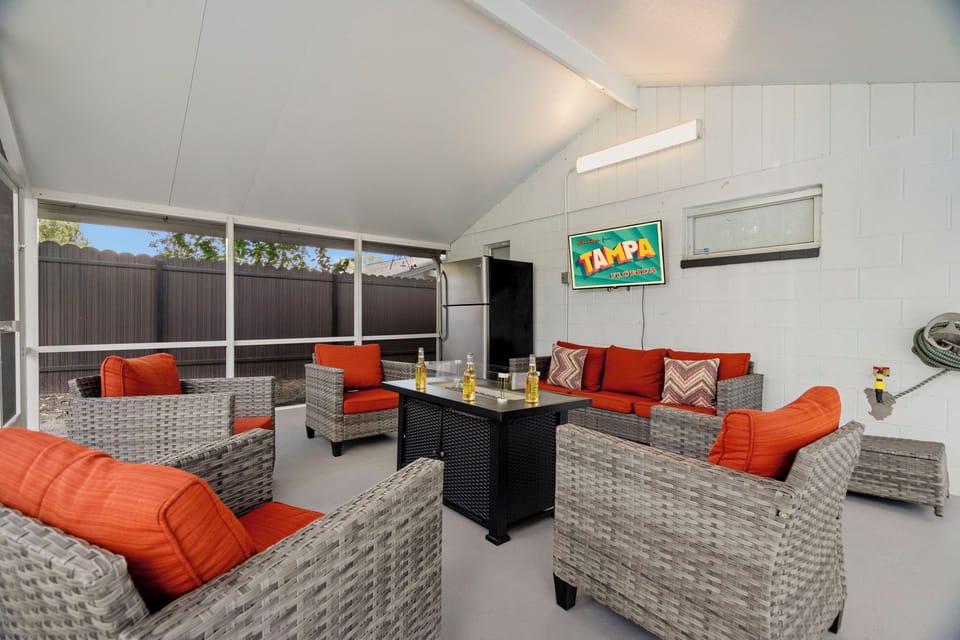 patio seating area with TV and fire pit table