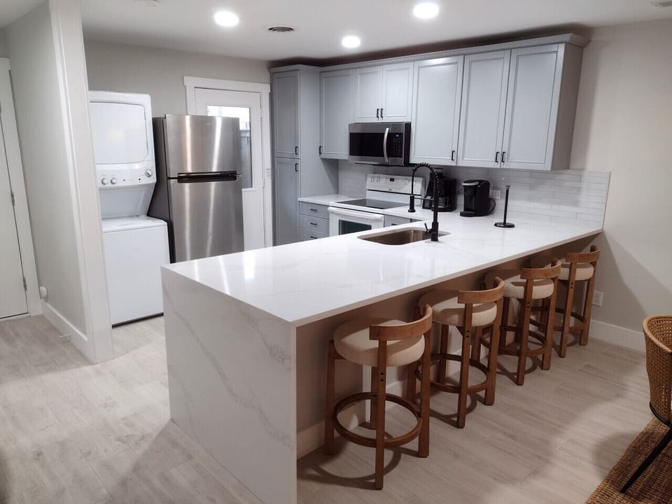Fully equipped kitchen with modern appliances and a spacious breakfast bar with seating—perfect for cooking, dining, and gathering at Hilton Head Hideaway.