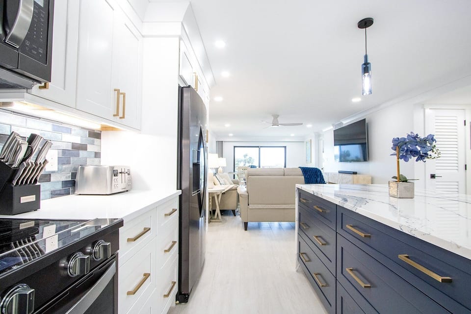 Sleek and modern kitchen with high-end appliances, a spacious island, and beautiful lighting.