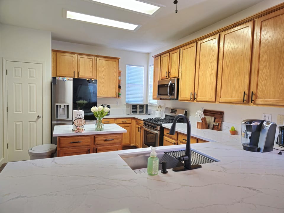 The kitchen has updated white quartz countertops that provides a clean backdrop.