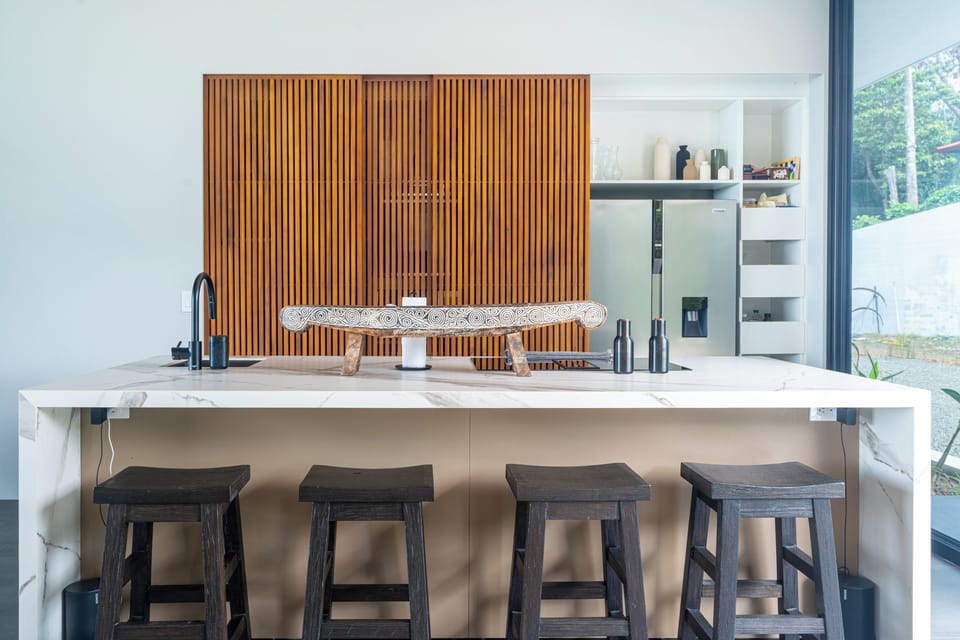 A contemporary kitchen with hidden sliding panels that discreetly conceal the kitchen from view, perfect for open-concept living