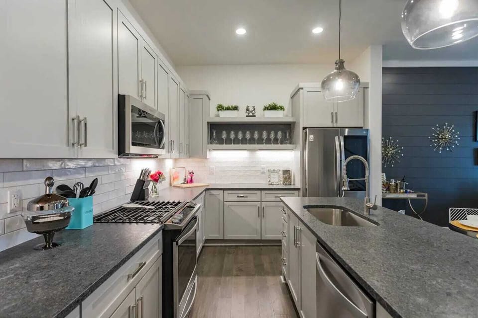 Kitchen: Fully equipped kitchen with stainless steel appliances and ample counter space.