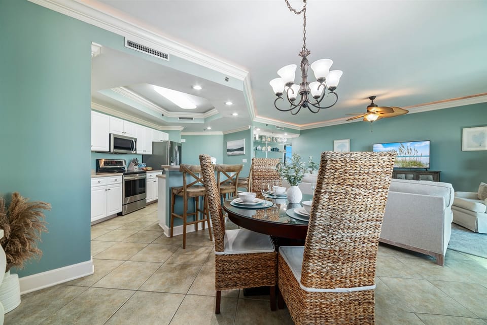 Gourmet kitchen with stainless steel appliances, granite countertops, and island seating. Open floor plan seamlessly connects to the living and dining areas.