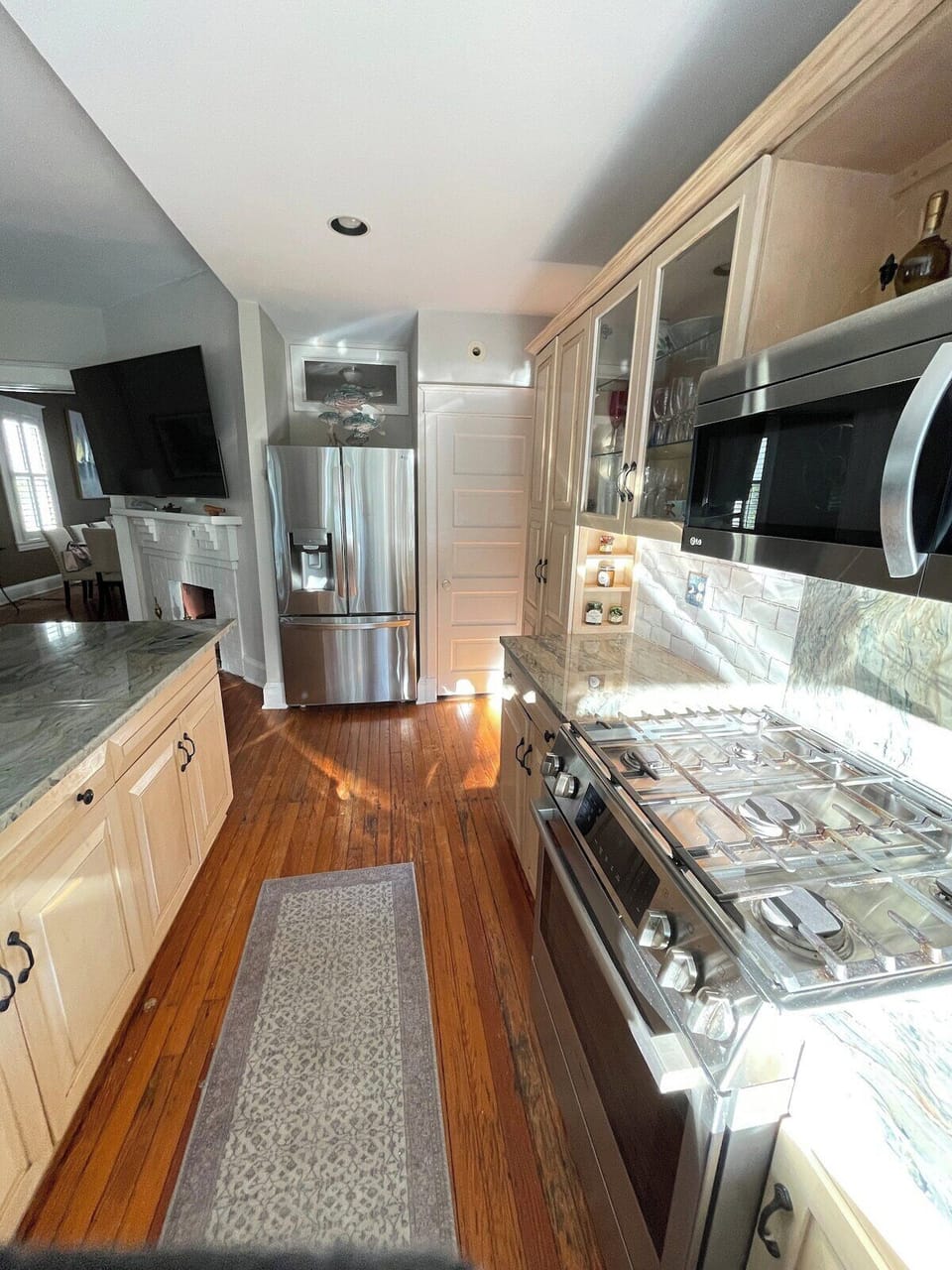 Kitchen and adjoining living room with ample seating and view of Spa Creek.