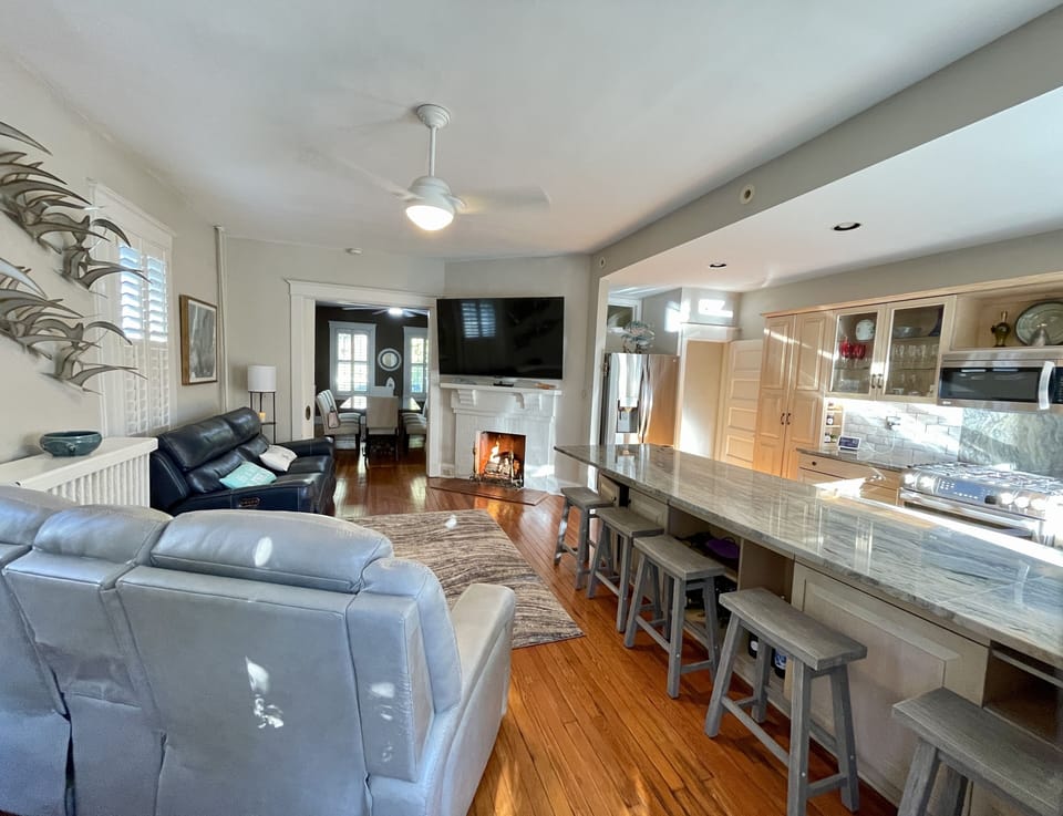 Kitchen and adjoining living room with ample seating and view of Spa Creek.