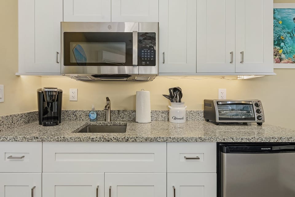 Keurig coffee maker, microwave, toaster oven, induction cooktop and cookware.