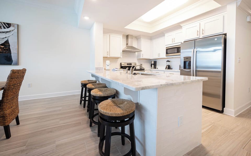 Sip your morning coffee at the breakfast bar and get ready for a beach day in this stylish space