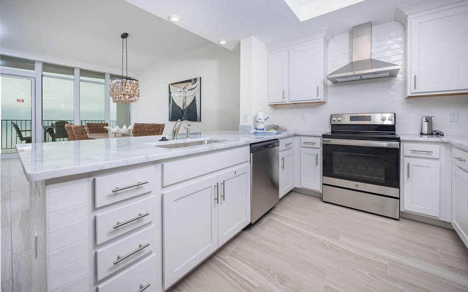 Prepare meals in this kitchen with elegant cabinetry, stainless appliances, and spacious countertops