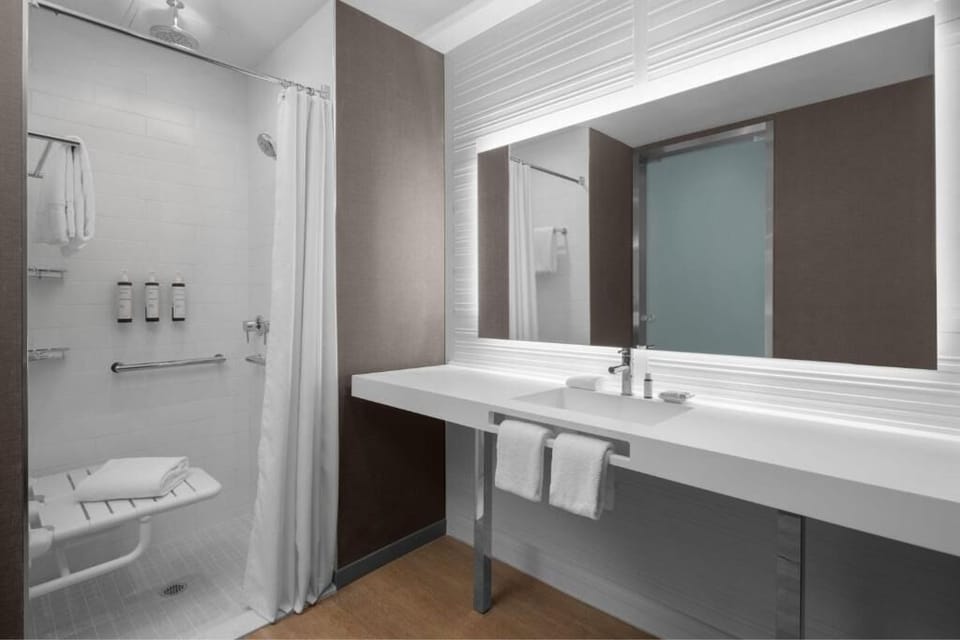 Rinse off in a spotless shower with bright, spa-like lighting.