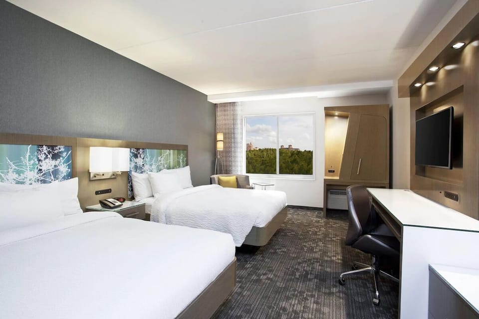 Unwind in bright double-queen room with calming window views.