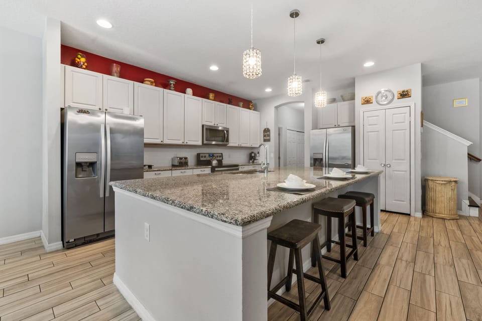 - Modern kitchen with granite countertops and island  
- Stainless steel appliances with bar seating area  
- Fully equipped for family meals and group dining